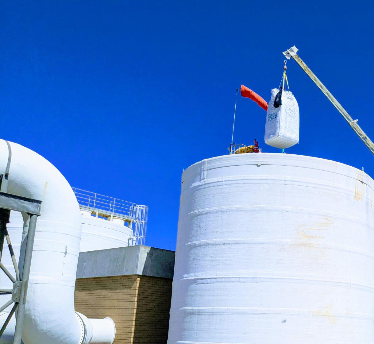A crane lowers a sack of Cell-Max into the north tower