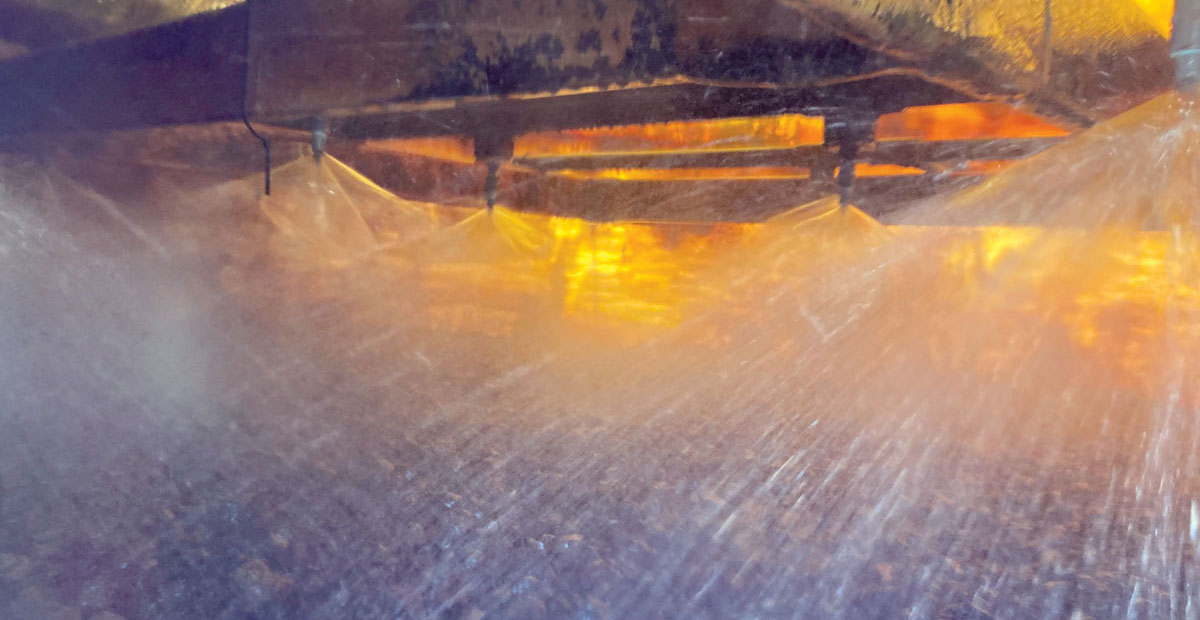 Water sprays from sprinklers inside a municipal biofilter